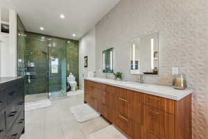 Full bath featuring double vanity, tile patterned flooring, a stall shower, toilet, and recessed lighting