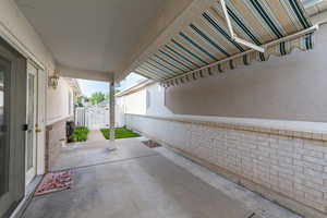View of patio featuring a gate
