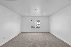 Empty room with carpet flooring, recessed lighting, and baseboards