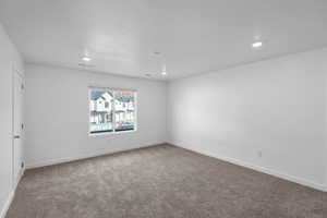 Empty room featuring recessed lighting, carpet floors, and baseboards