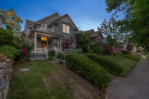 View of front of house with a balcony, a front lawn, and a porch