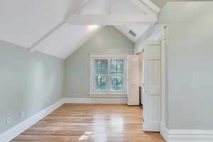 Additional living space with light wood finished floors and baseboards