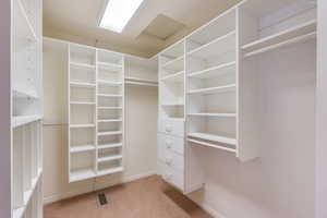Walk in closet featuring light carpet