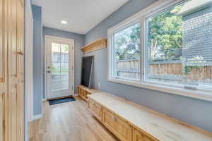 Mudroom featuring light wood-style floors, baseboards, and recessed lighting