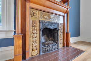 Detailed view of a high end fireplace and wood finished floors