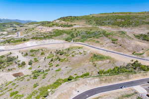 Aerial overview of property's location with a mountain backdrop and rural landscape
