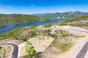 Aerial view of property and surrounding area with a water and mountain view and property boundaries highlighted