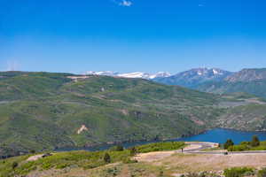 View of mountain backdrop featuring a nearby body of water