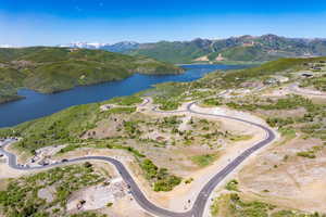 Aerial view of property's location with a water and mountain view