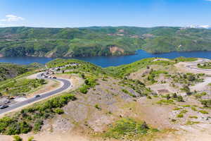 Aerial view of property's location with a water and mountain view