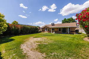 Back of property featuring stucco siding, a yard, a patio area, and central AC unit