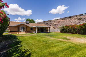 Rear view of property featuring stucco siding, central air condition unit, and a shingled roof