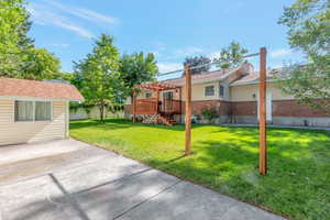 View of yard with a pergola, a covered deck area, and 1 of 2 sheds.