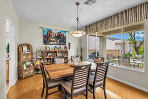 Dining area with light wood finished floors and baseboards
