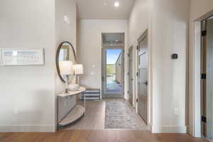 Foyer entrance featuring wood finished floors and baseboards