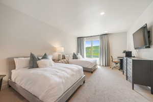 Bedroom featuring light carpet, recessed lighting, and an office area