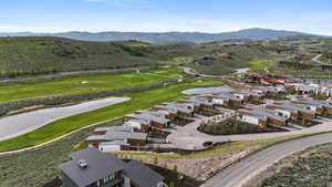 Aerial view of residential area with a water and mountain view and a local golf course