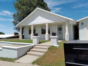 Rambler featuring a porch and stucco siding