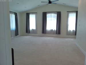 Spacious master bedroom on main level with vaulted ceiling, lots of natural light, giant walk-in closet, and large bathroom with separate bath and tub.