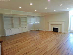 Spacious family room view with built-in cabinets and fireplace