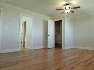 Bedroom on main level with walk-in-closet and bathroom with double vanity and large shower