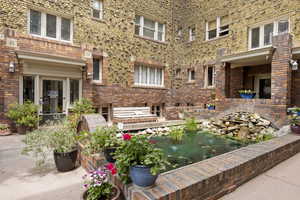 View of patio featuring a small pond
