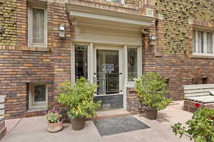 Property entrance featuring brick siding