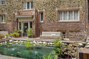 View of patio with a small pond