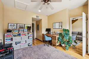 Office with wood finished floors, a ceiling fan, and recessed lighting