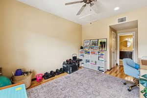 Home office with attic access, wood finished floors, a ceiling fan, baseboards, and recessed lighting