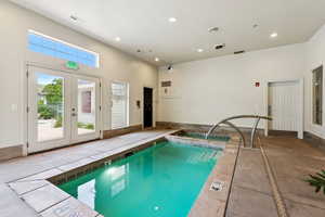 Indoor community pool featuring french doors