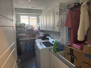 Laundry area with washer and clothes dryer and cabinet space