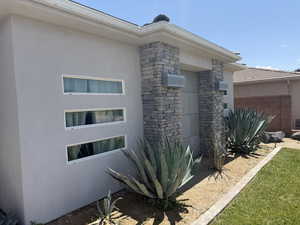View of side of home with stucco siding