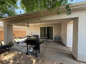 View of patio featuring a grill