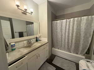 Full bath featuring vanity and shower / bath combo with shower curtain
