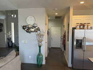 Hall with recessed lighting and baseboards