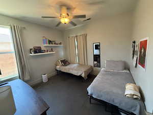 Carpeted bedroom with baseboards and a ceiling fan