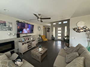 Living area featuring ceiling fan and a high end fireplace