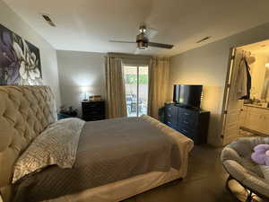 Carpeted bedroom featuring access to outside and ceiling fan