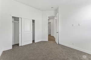 3rd bedroom featuring carpet floors, baseboards, and a closet