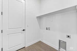 Laundry room featuring washer hookup, hookup for an electric dryer, baseboards, and wood finished floors