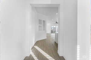 Hall featuring baseboards, LVP finished floors, and recessed lighting