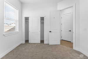 2nd bedroom with carpet, baseboards, and a closet