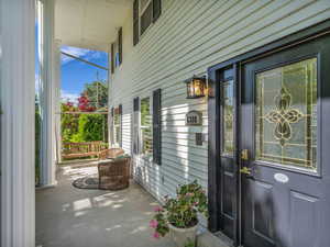 Entrance to property featuring covered porch
