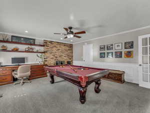Playroom with crown molding, carpet, ceiling fan, billiards, and a wainscoted wall