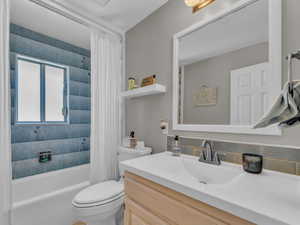 Full bath featuring vanity, toilet, and shower / bath combo