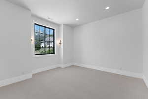 Unfurnished room featuring light colored carpet, recessed lighting, and baseboards