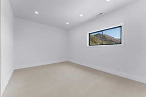 Unfurnished room with light colored carpet, recessed lighting, and baseboards
