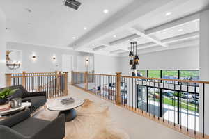 Corridor with beamed ceiling, recessed lighting, a chandelier, carpet, and coffered ceiling