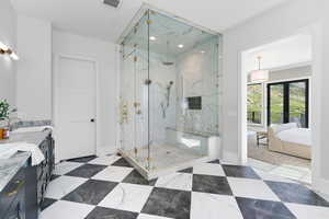 Ensuite bathroom with a marble finish shower, baseboards, double vanity, and recessed lighting